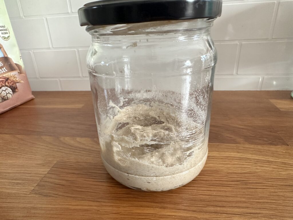 Freshly mixed sourdough starter on day 1, flour and water combined in a glass jar